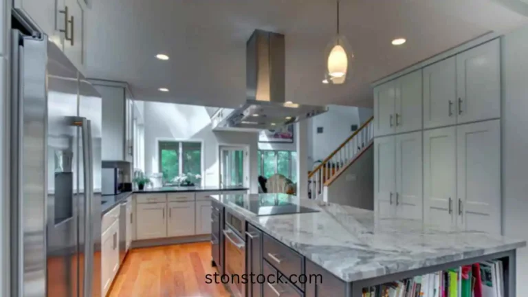 Azul Aran polished granite sits atop a gray center island in this Boston kitchen by Pegasus Design-to-Build LLC.